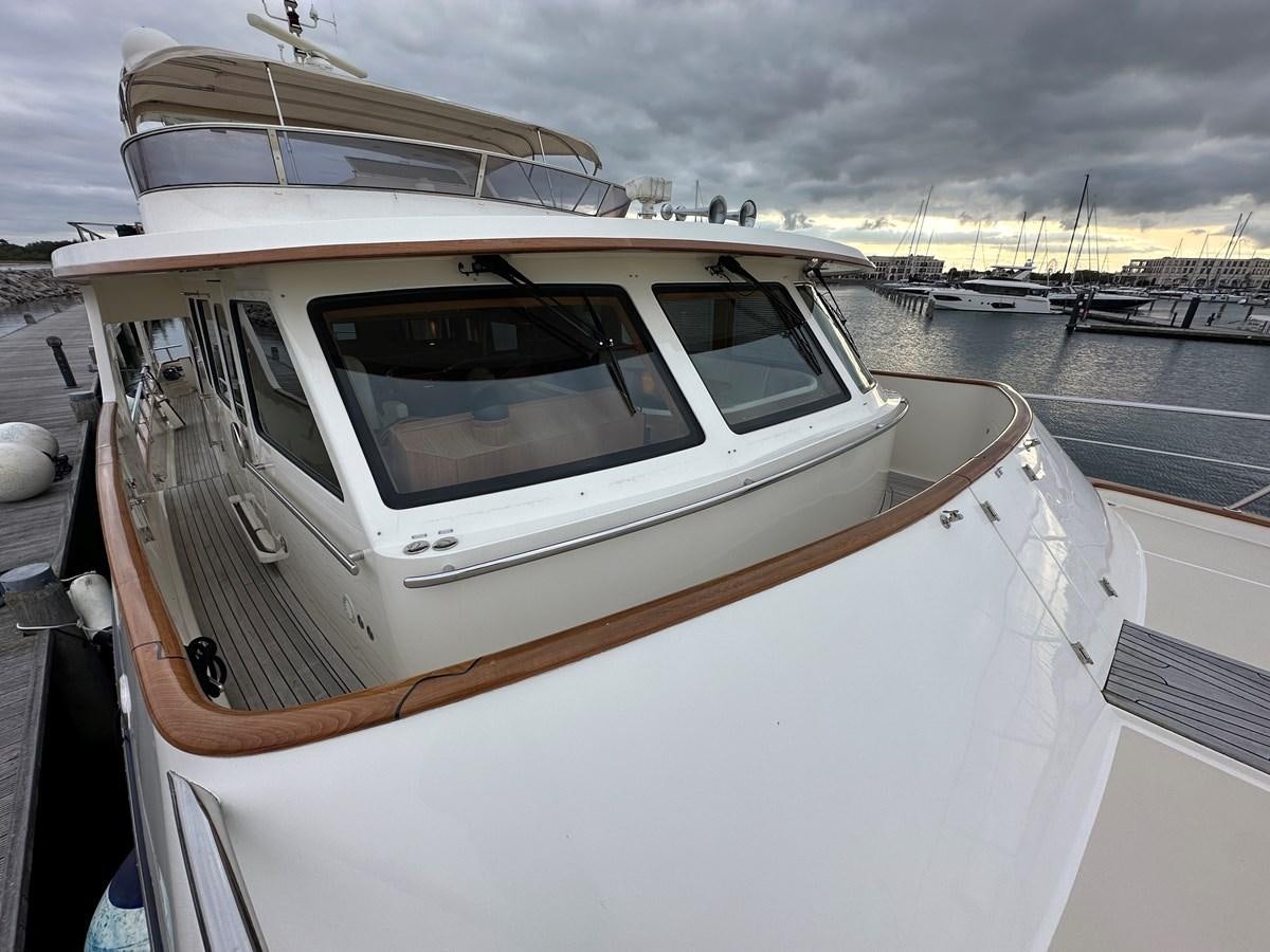 a white yacht in a harbor aboard AZURA Yacht for Sale