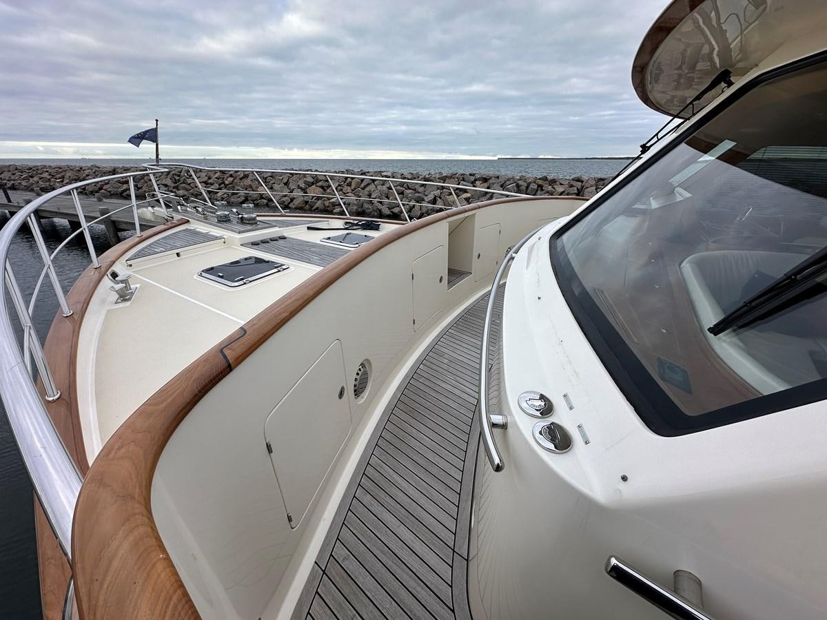 a person's hand on a steering wheel of a boat aboard AZURA Yacht for Sale