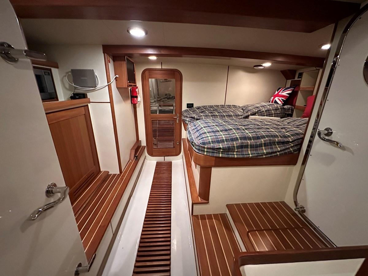 a bedroom with a bed and a television aboard AZURA Yacht for Sale