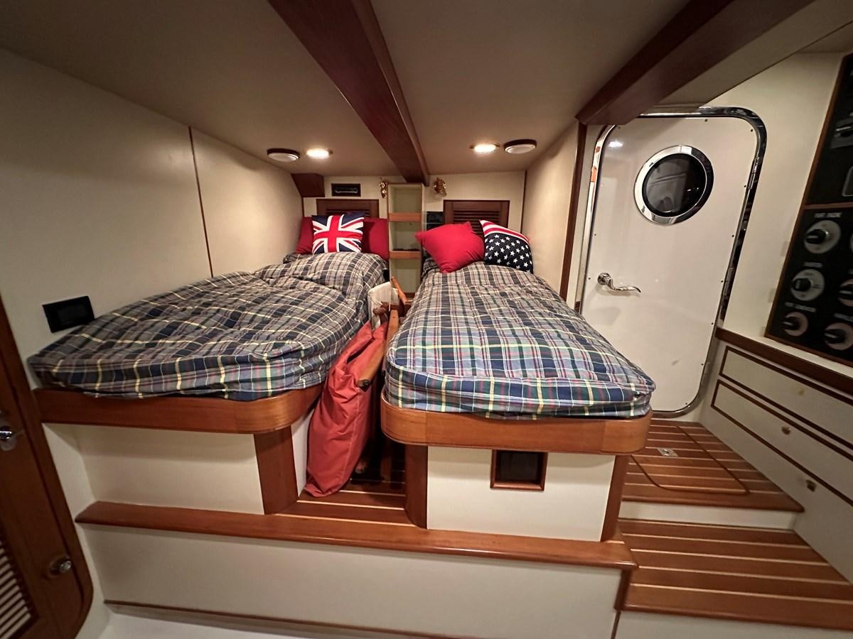 a room with a bed and a washing machine aboard AZURA Yacht for Sale