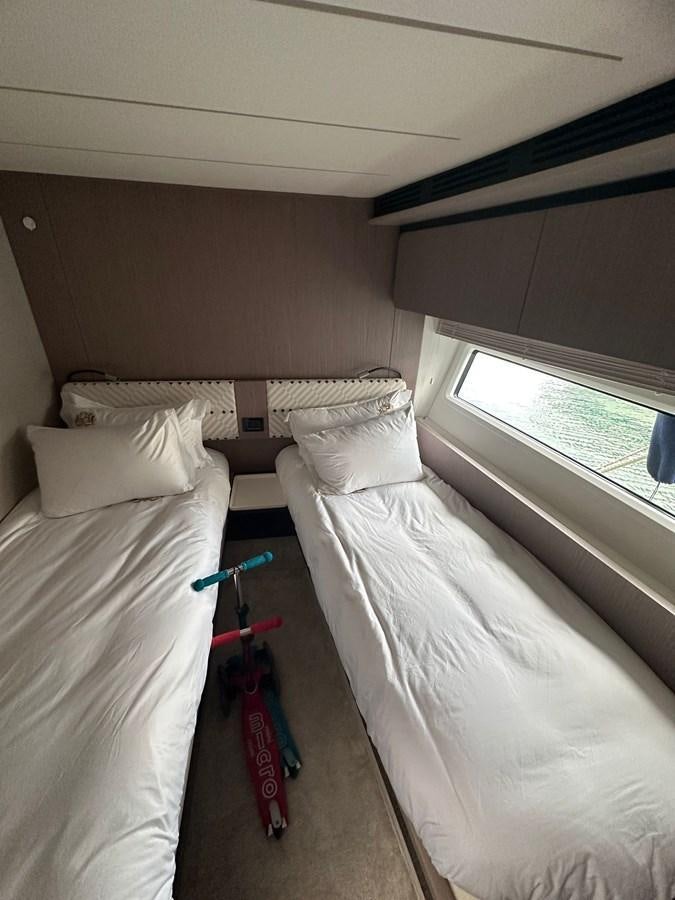 a bedroom with two beds aboard BLUE Yacht for Sale