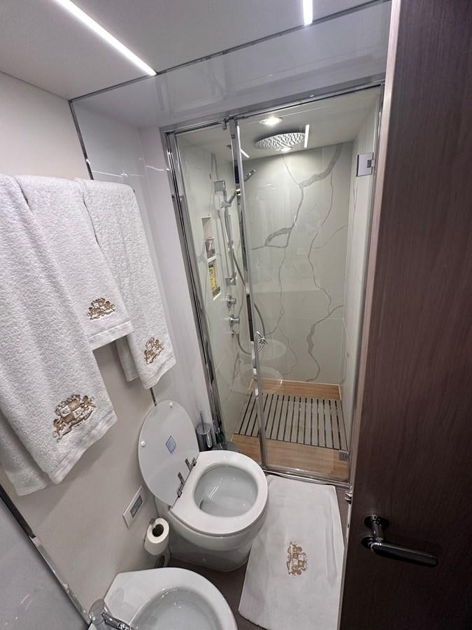 a bathroom with a toilet and a shower aboard BLUE Yacht for Sale