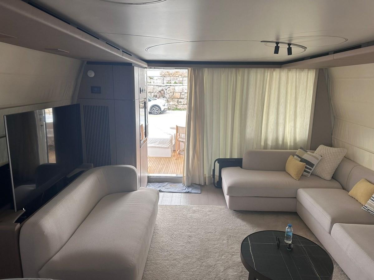 a living room with a couch and a sliding glass door aboard BLUE Yacht for Sale