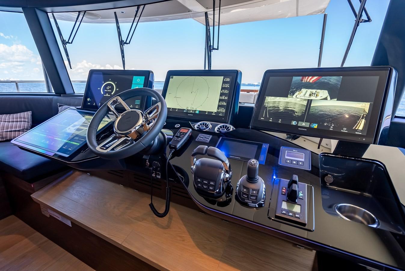 a table with a couple of computers and a laptop on it aboard AQUARIUS Yacht for Sale