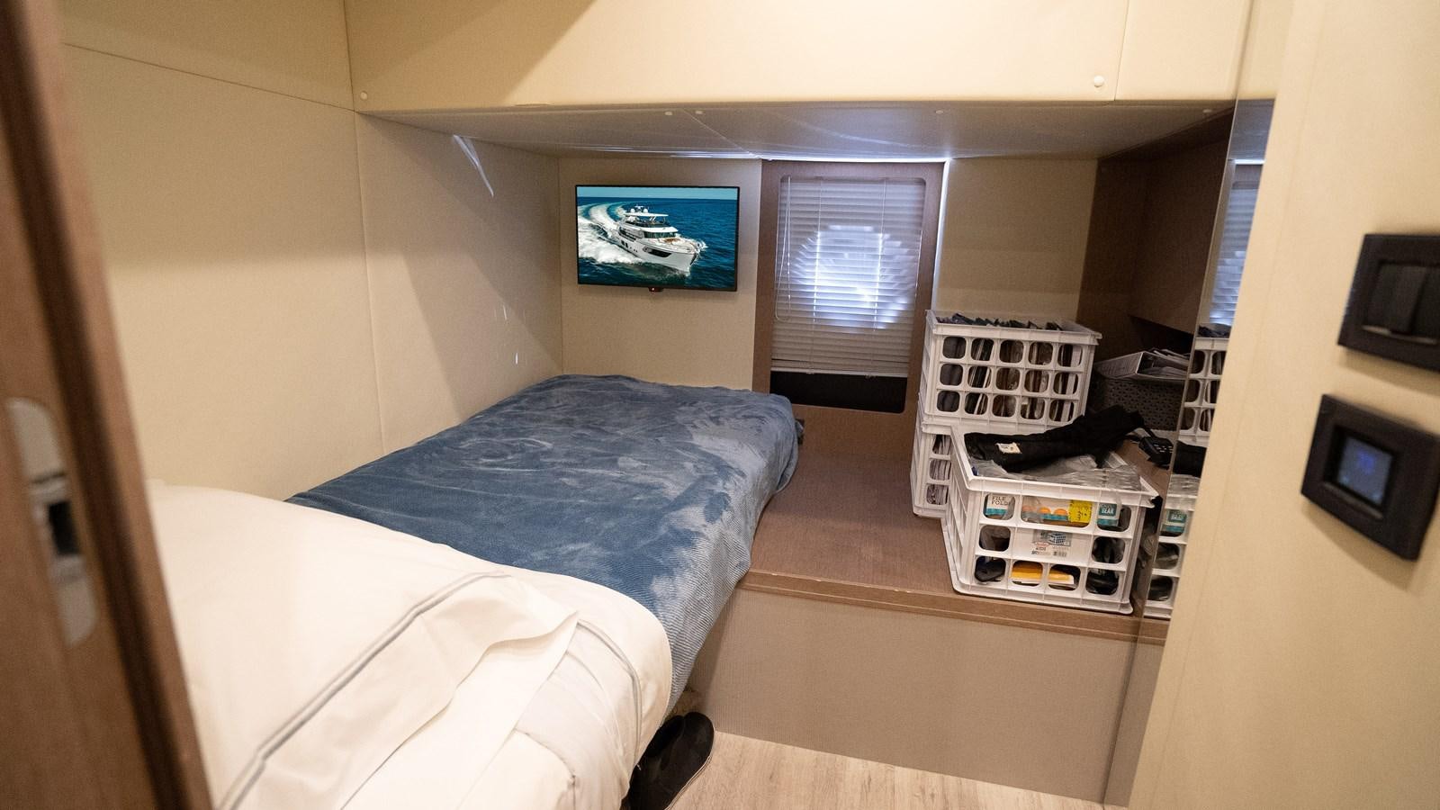 a room with a bed and a television aboard AQUARIUS Yacht for Sale