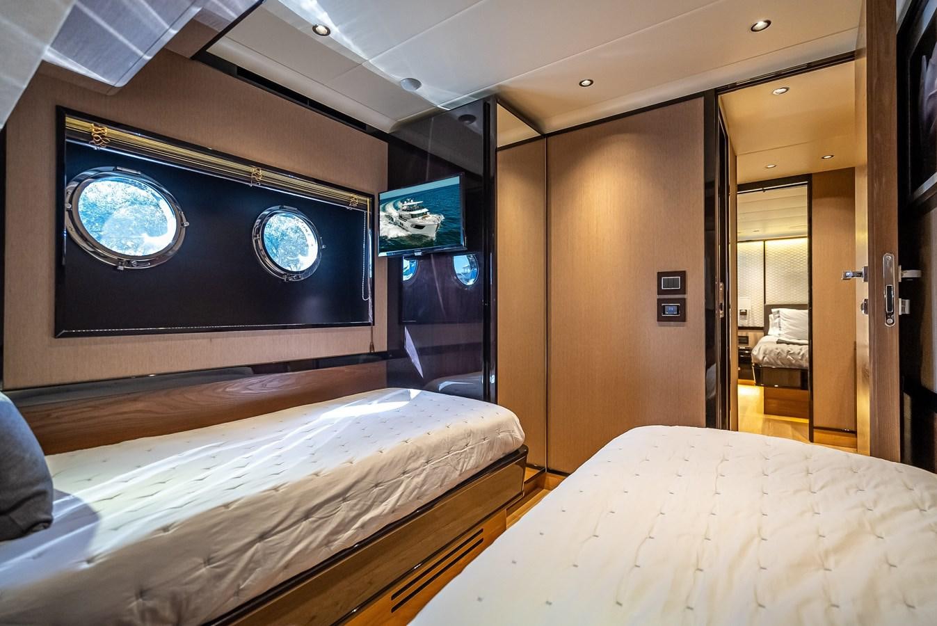 a room with a bed and a screen on the wall aboard AQUARIUS Yacht for Sale