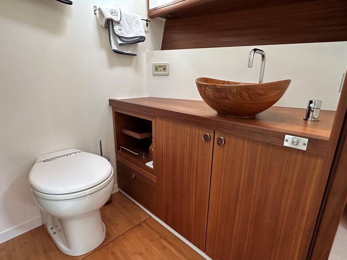 a bathroom with a toilet and sink aboard REGINA Yacht for Sale