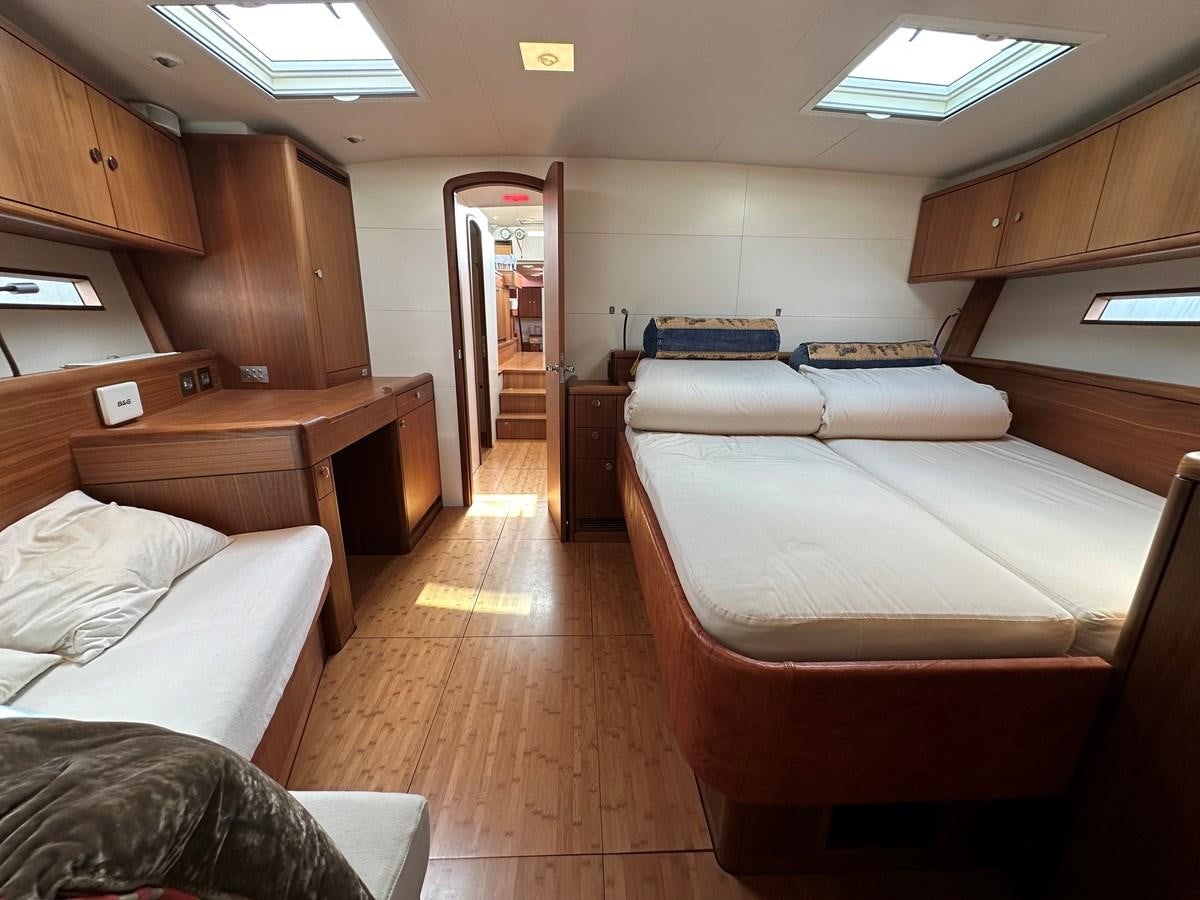 a room with a bed and a desk aboard REGINA Yacht for Sale