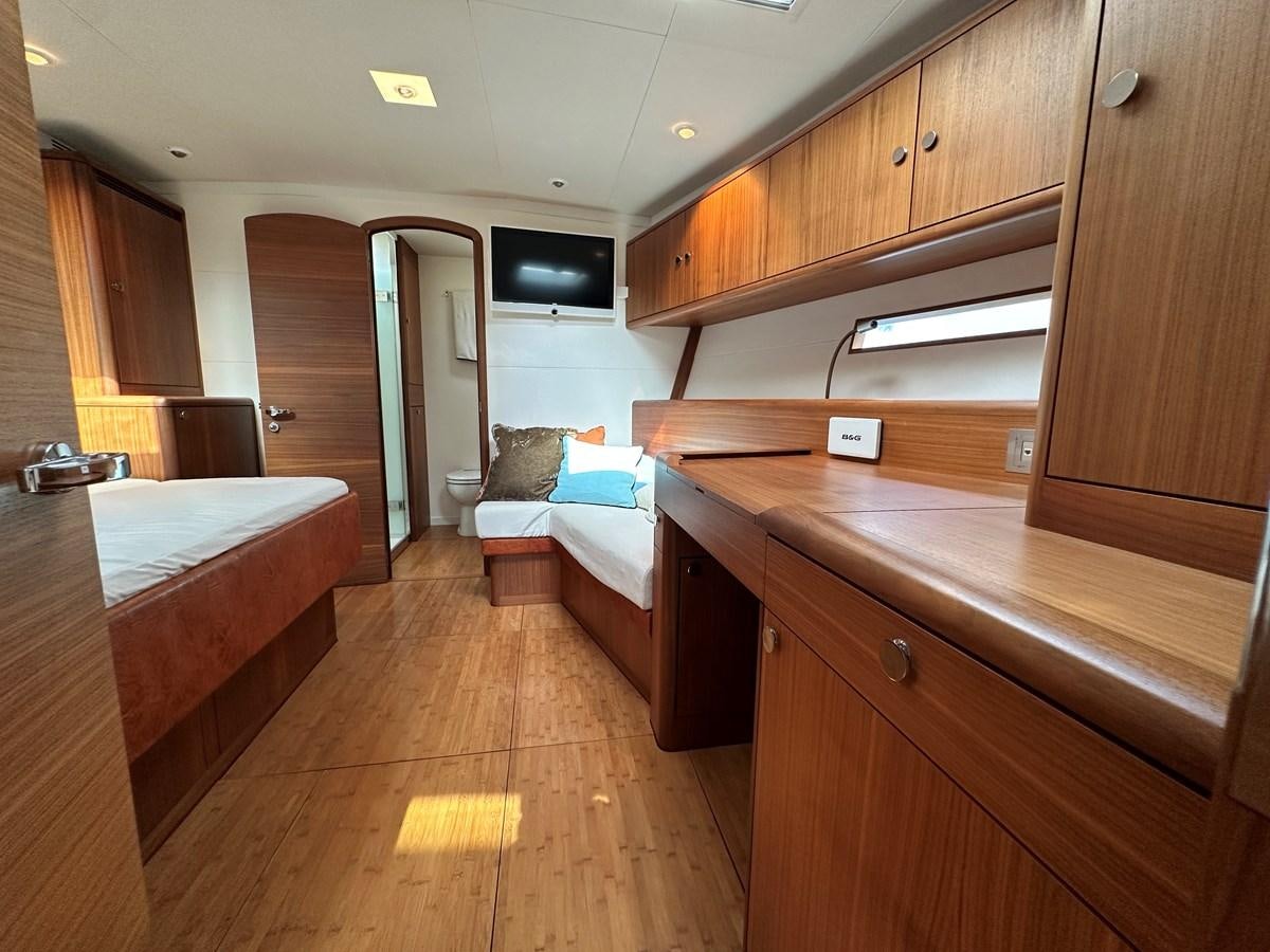 a room with a bed and a tv aboard REGINA Yacht for Sale