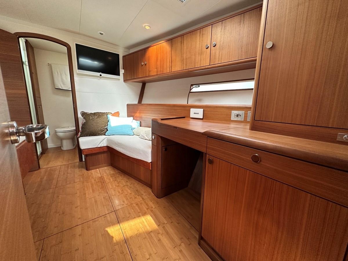 a bedroom with a wood floor aboard REGINA Yacht for Sale