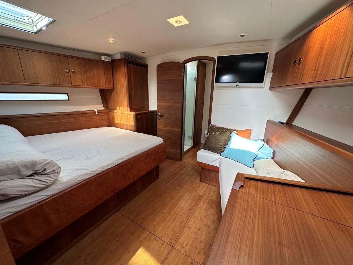 a room with wooden furniture aboard REGINA Yacht for Sale