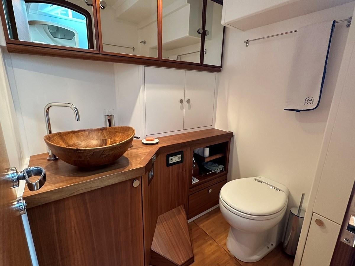 a bathroom with a sink toilet and a mirror aboard REGINA Yacht for Sale