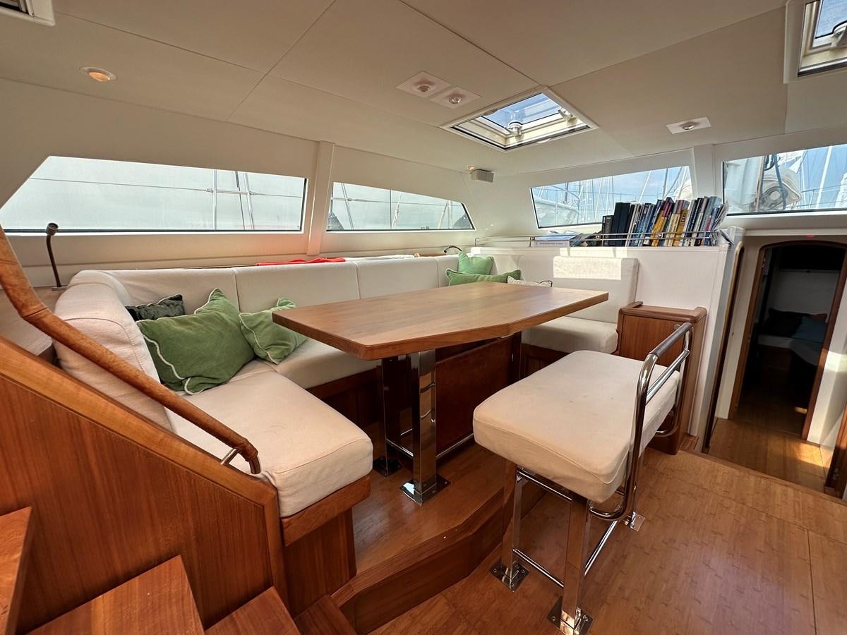 a room with a couch and a table and chairs aboard REGINA Yacht for Sale
