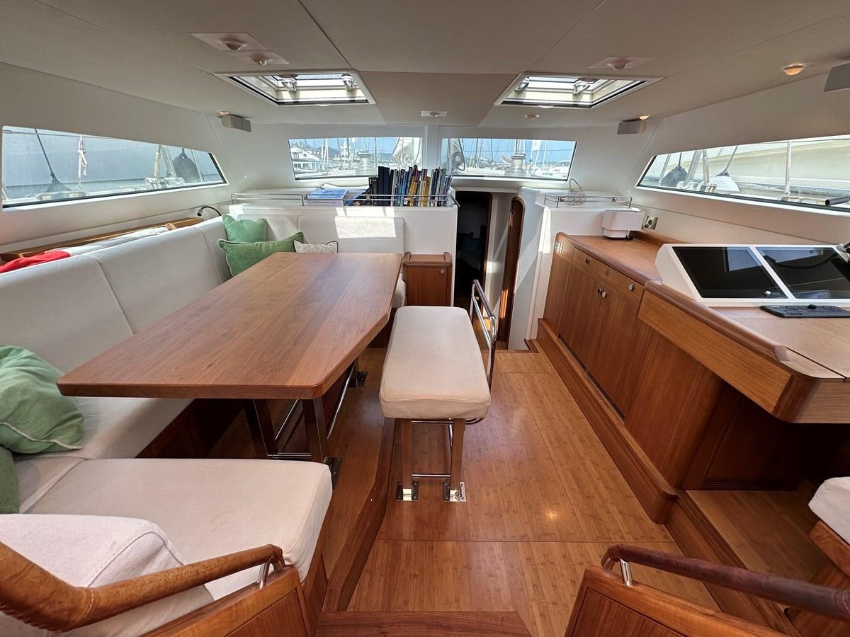 a room with tables and chairs aboard REGINA Yacht for Sale