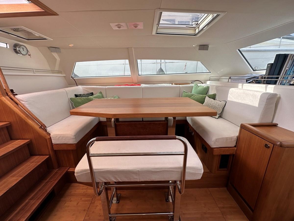 a room with a table and chairs aboard REGINA Yacht for Sale