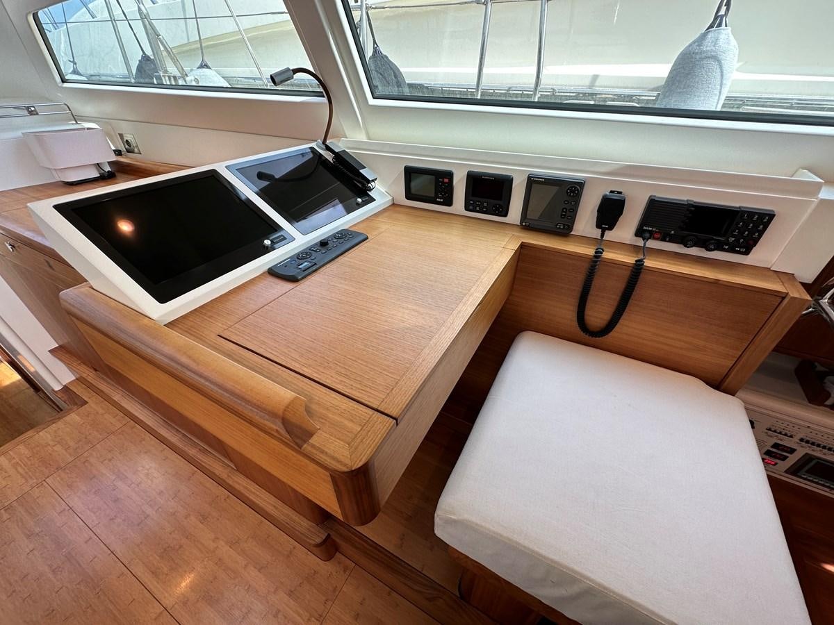 a desk with a laptop on it aboard REGINA Yacht for Sale