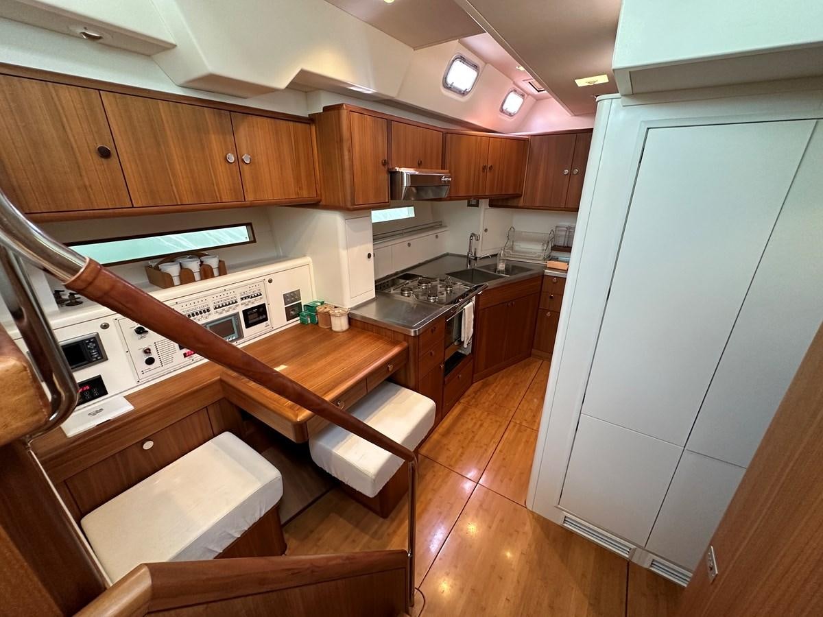 a kitchen with wooden cabinets aboard REGINA Yacht for Sale