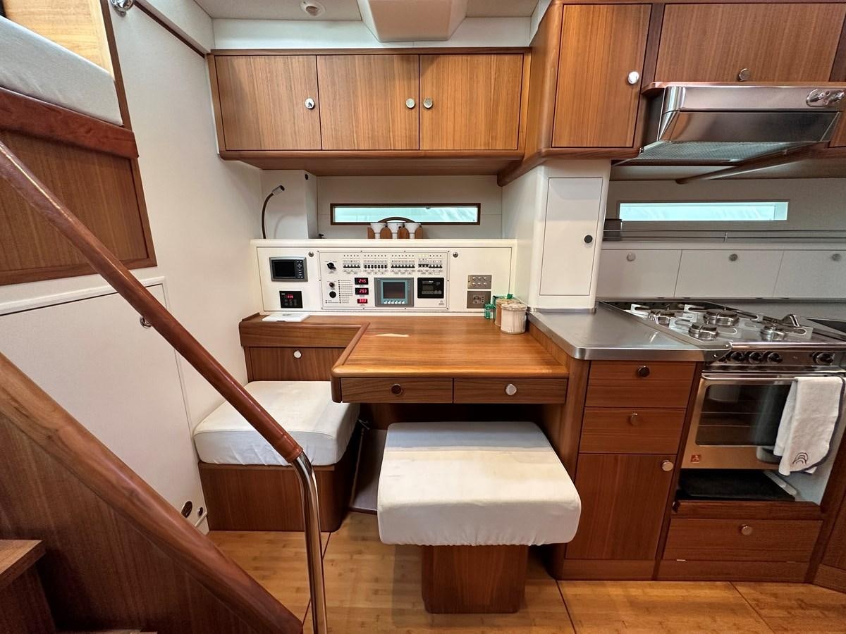 a kitchen with wooden cabinets aboard REGINA Yacht for Sale