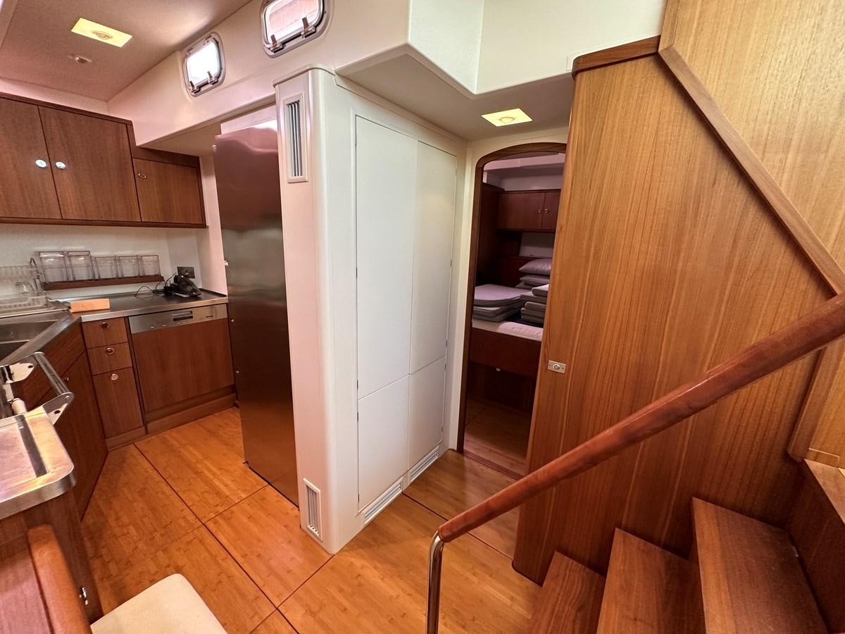 a kitchen with a fridge aboard REGINA Yacht for Sale