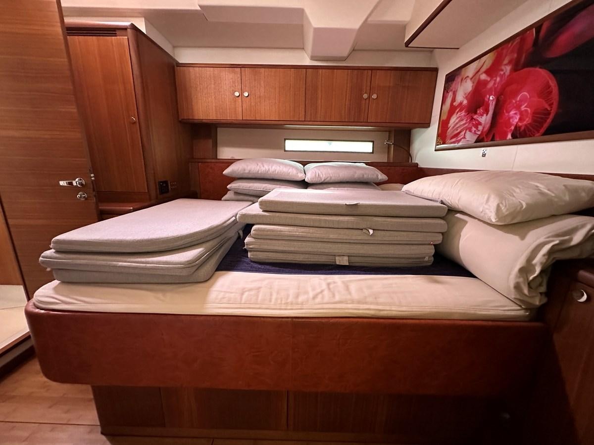 a room with a bed and a television aboard REGINA Yacht for Sale