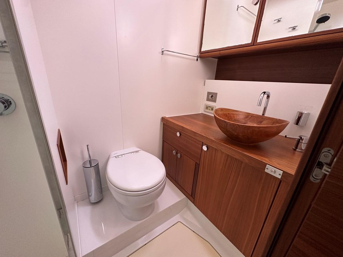 a bathroom with a toilet and sink aboard REGINA Yacht for Sale