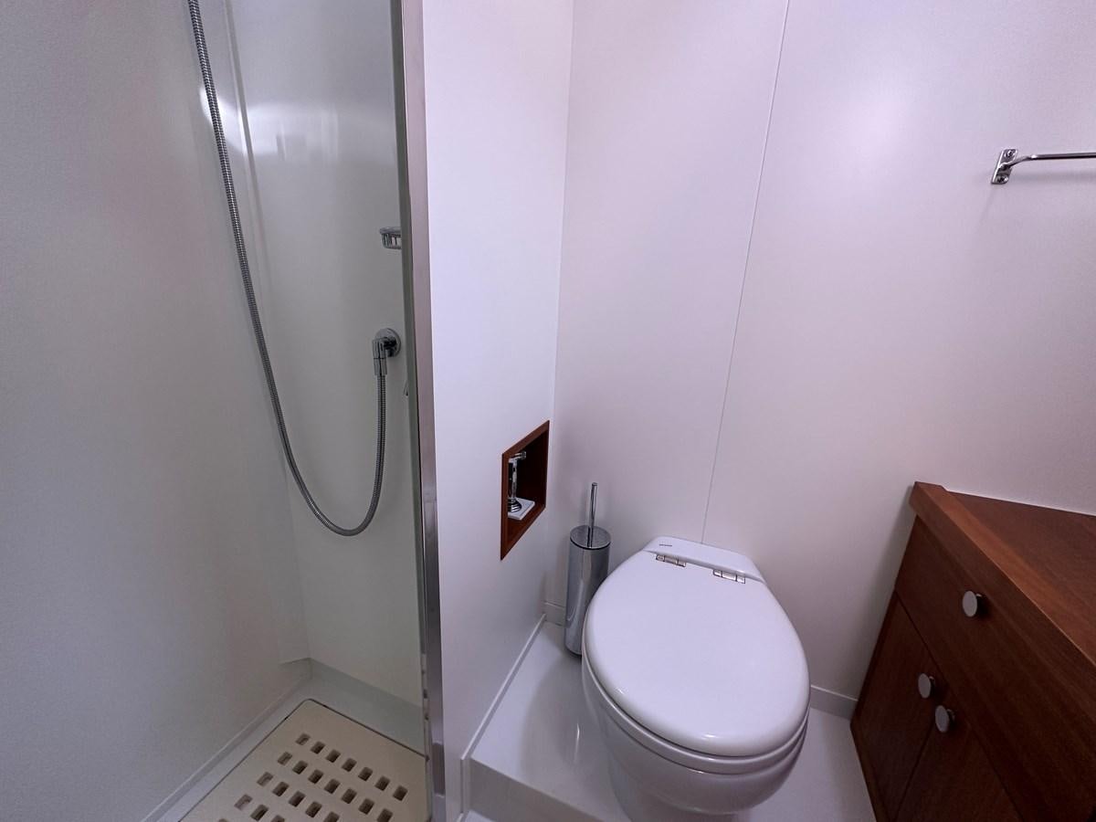 a bathroom with a toilet and a shower aboard REGINA Yacht for Sale