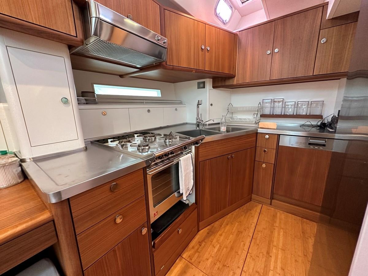 a kitchen with wooden cabinets aboard REGINA Yacht for Sale