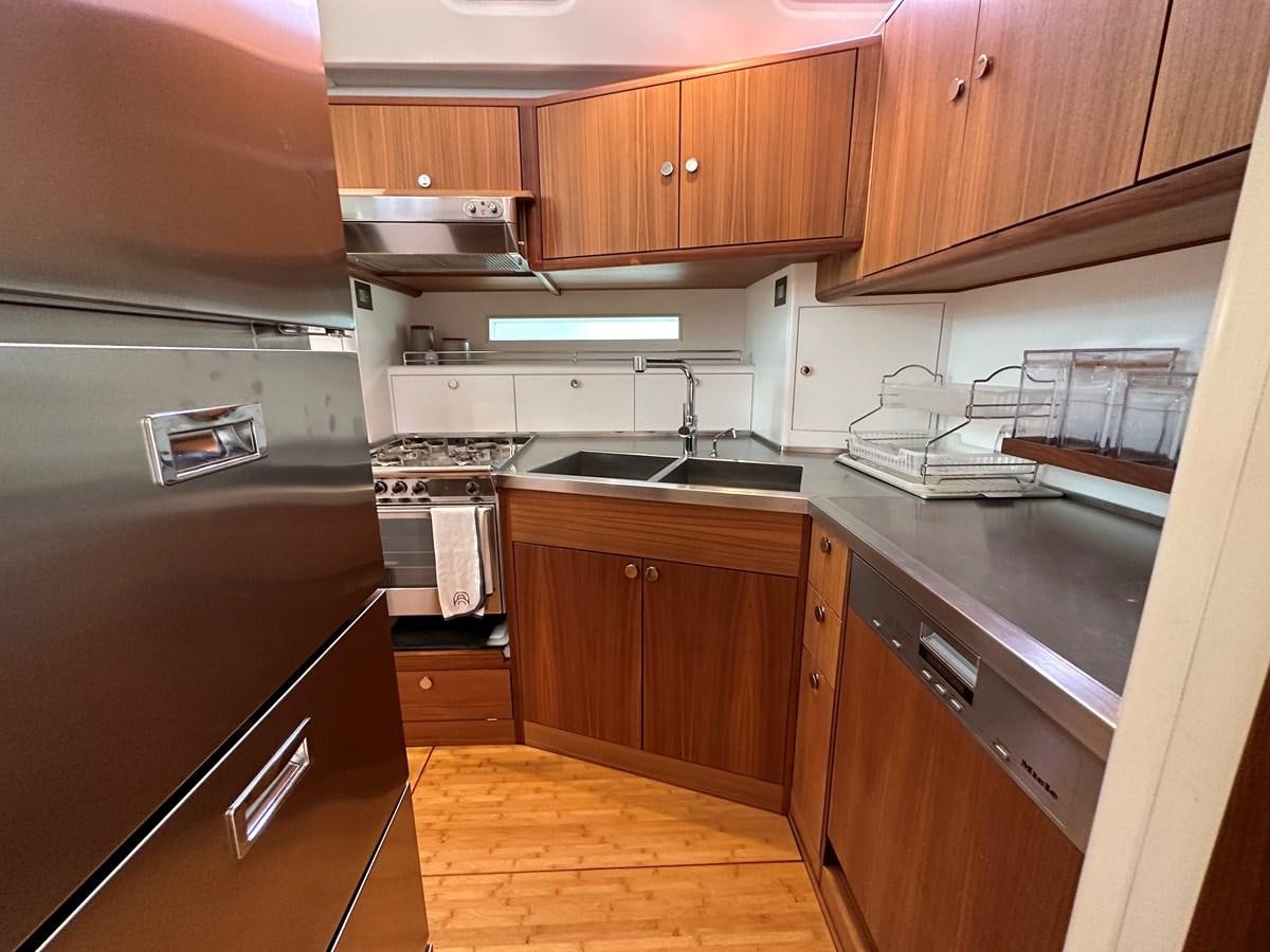 a kitchen with wooden cabinets aboard REGINA Yacht for Sale