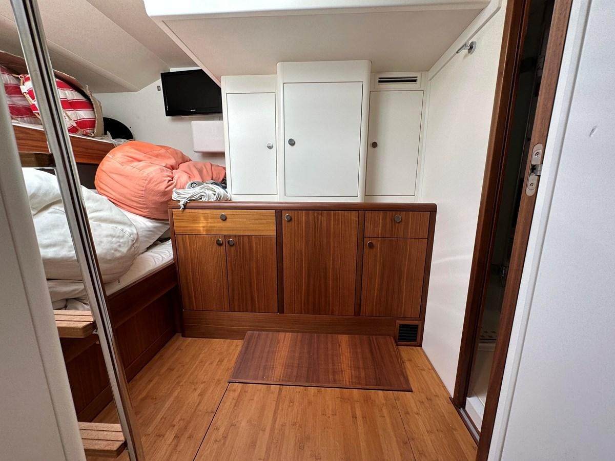 a room with a bed and a television aboard REGINA Yacht for Sale