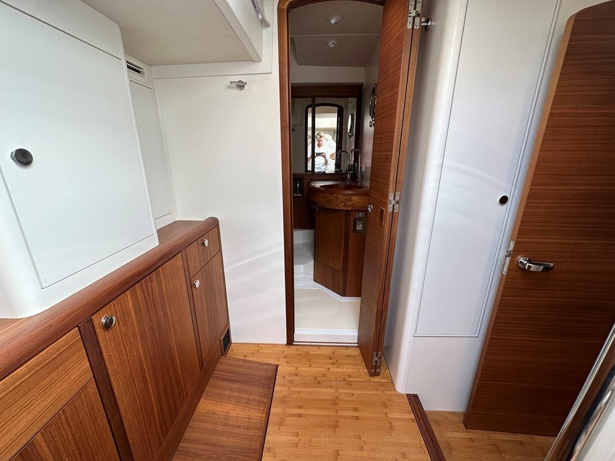 a bathroom with a wood floor aboard REGINA Yacht for Sale