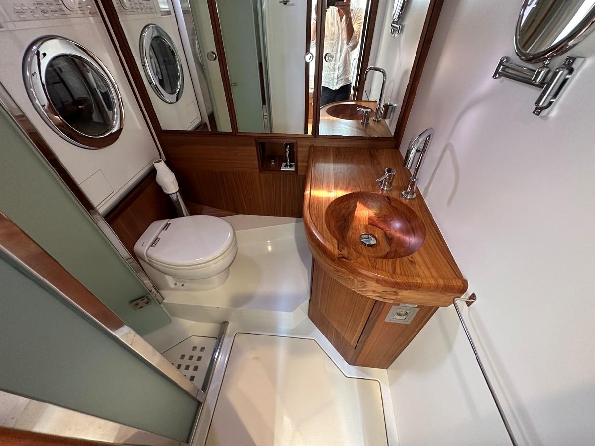 a bathroom with a wood sink aboard REGINA Yacht for Sale