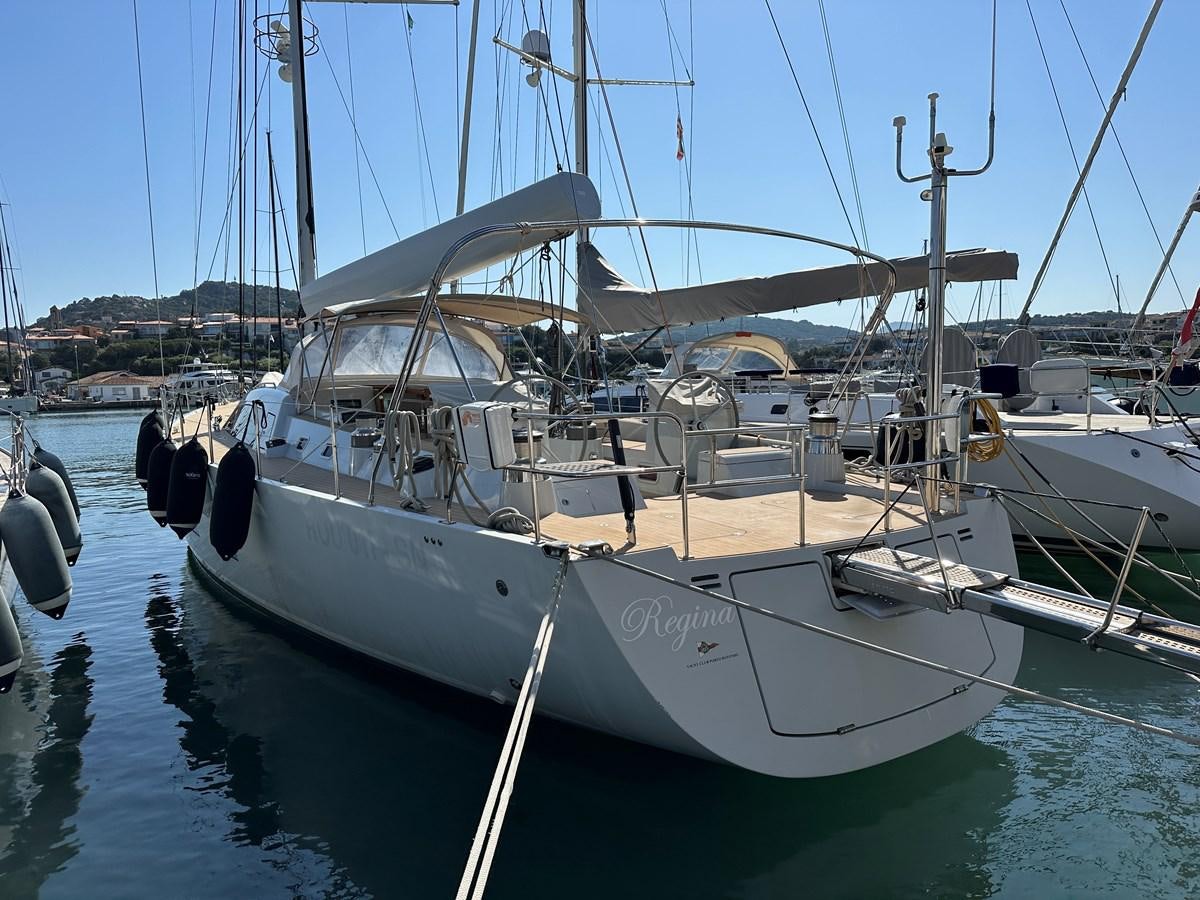 a boat docked in a harbor aboard REGINA Yacht for Sale