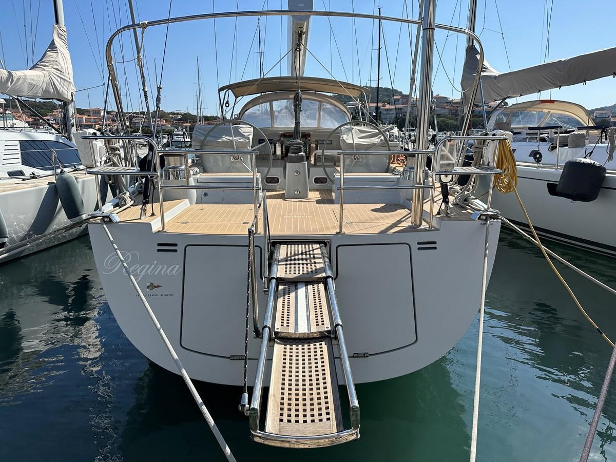 a boat docked in a harbor aboard REGINA Yacht for Sale