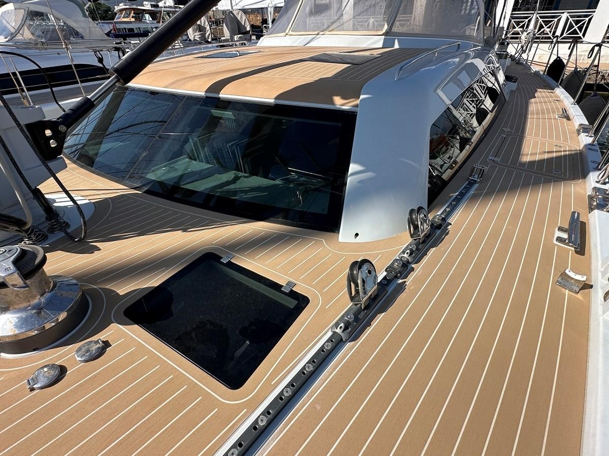 a large white guitar on a wooden surface aboard REGINA Yacht for Sale