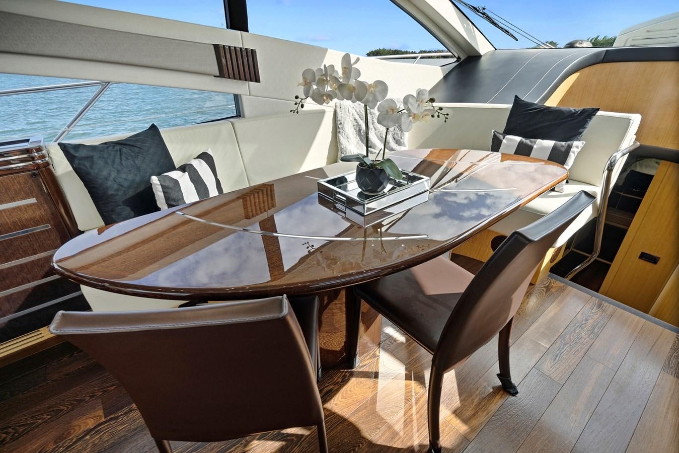 a table with chairs around it aboard EL REY Yacht for Sale