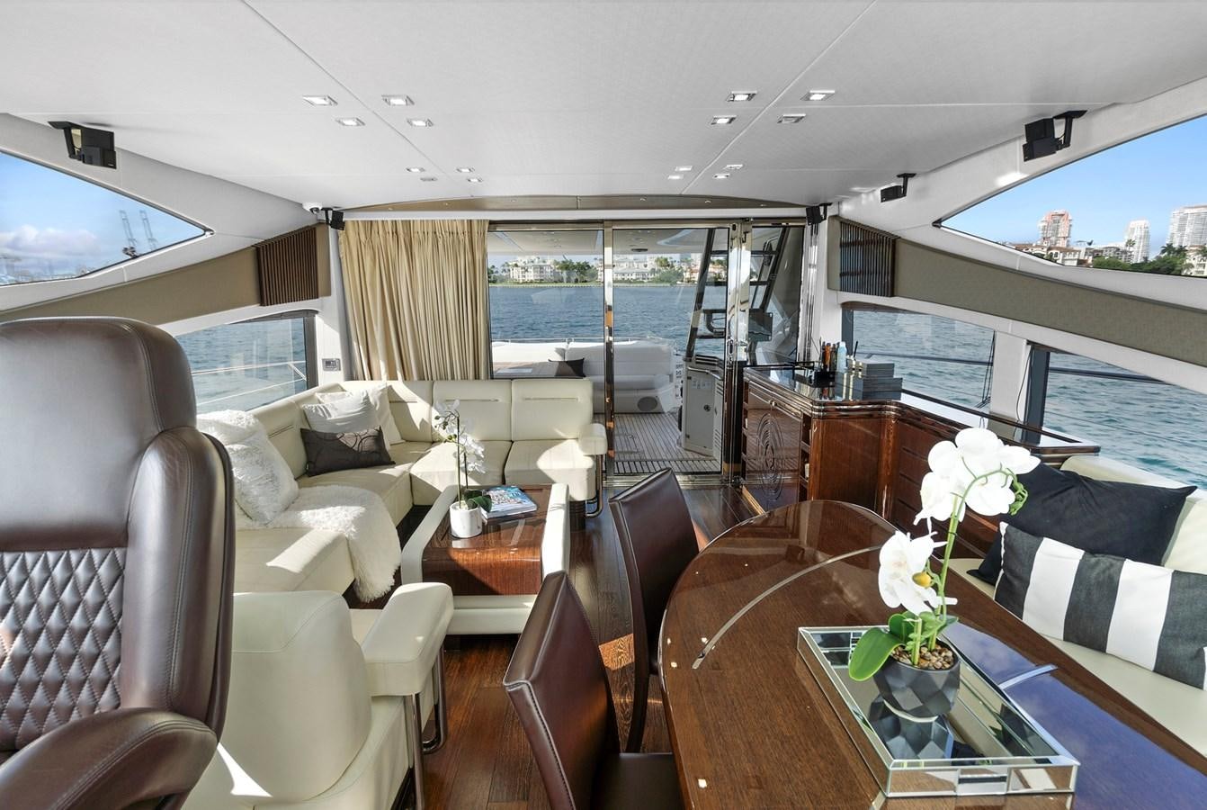 a living room with a table and chairs aboard EL REY Yacht for Sale