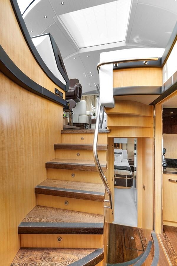 a wooden staircase with a wood railing aboard EL REY Yacht for Sale