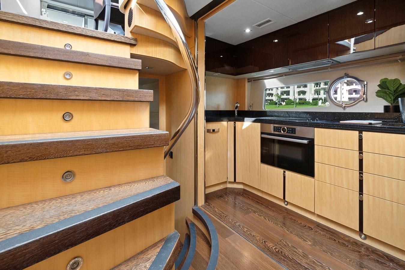 a kitchen with wooden cabinets aboard EL REY Yacht for Sale