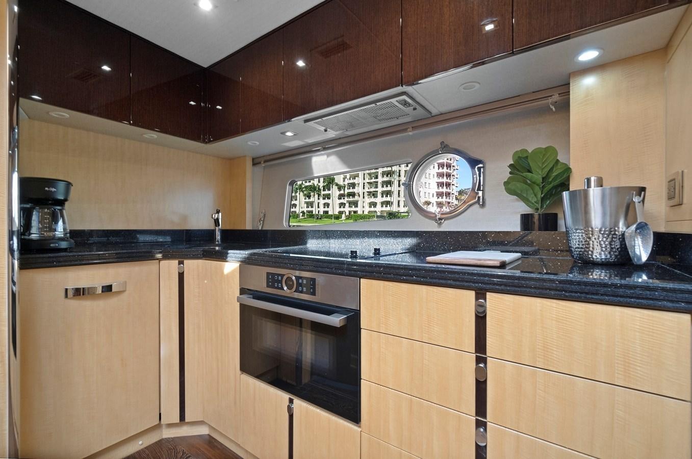 a kitchen with wooden cabinets aboard EL REY Yacht for Sale