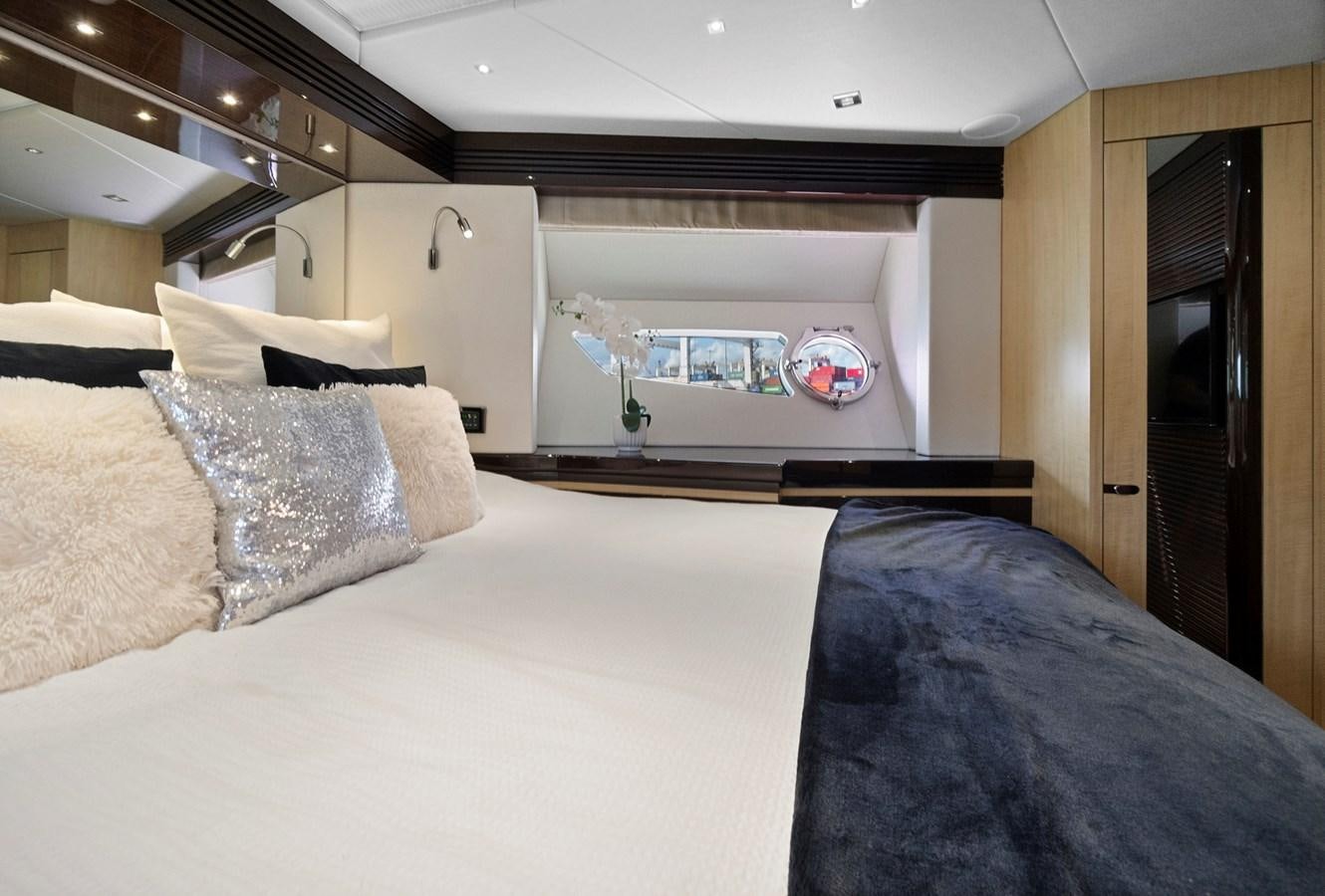 a bed with a blue blanket aboard EL REY Yacht for Sale