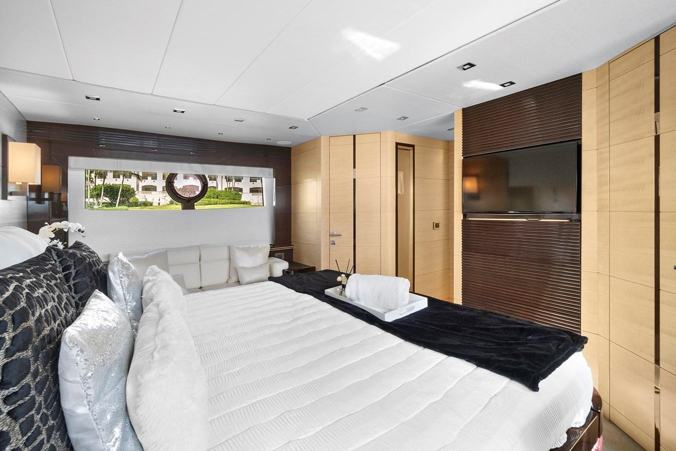 a bedroom with a bed and a large mirror aboard EL REY Yacht for Sale