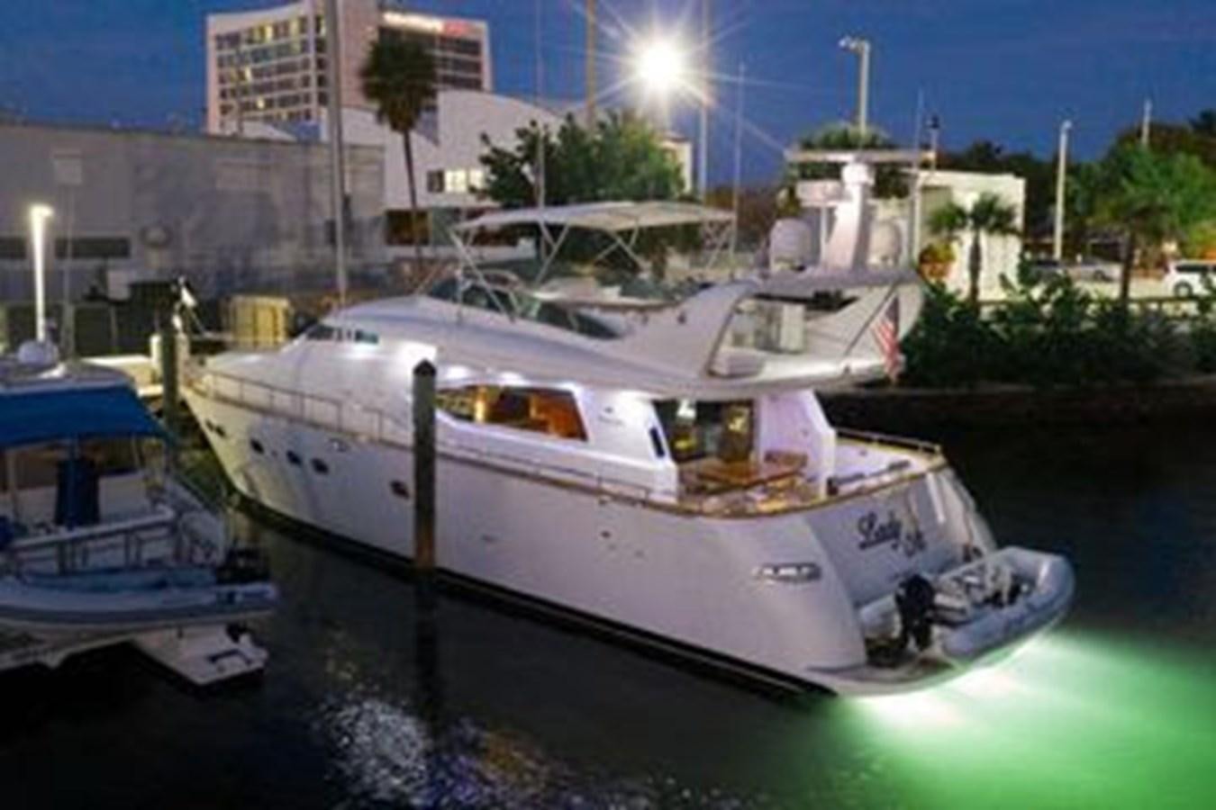 a couple of boats sit in a harbor aboard 1997 MAIORA FIPA 70' FLYBRIDGE Yacht for Sale