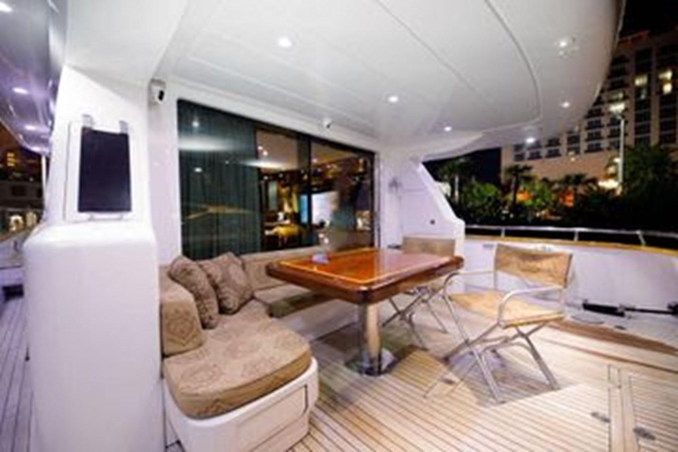 a living room with a large window aboard 1997 MAIORA FIPA 70' FLYBRIDGE Yacht for Sale