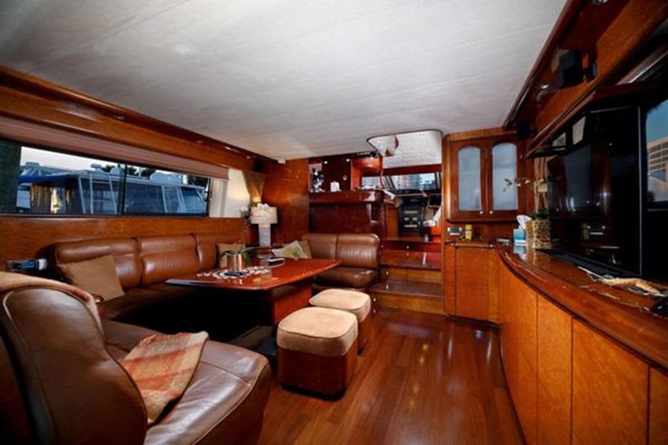 a living room with wood furniture aboard 1997 MAIORA FIPA 70' FLYBRIDGE Yacht for Sale