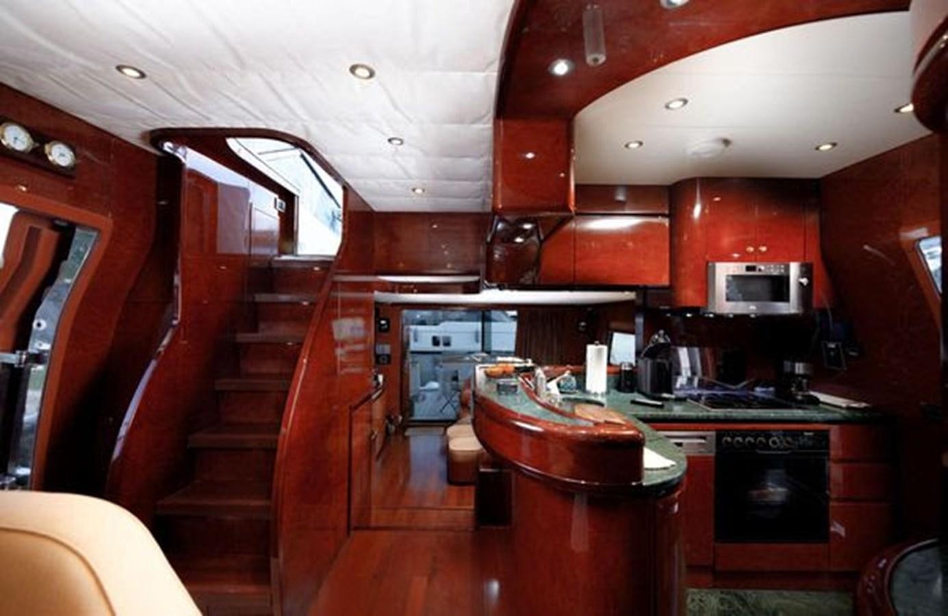 a kitchen with wooden cabinets aboard 1997 MAIORA FIPA 70' FLYBRIDGE Yacht for Sale