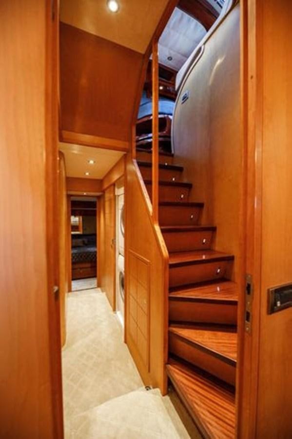 a wooden staircase in a house aboard 1997 MAIORA FIPA 70' FLYBRIDGE Yacht for Sale
