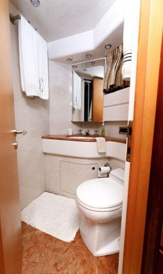 a bathroom with a toilet and sink aboard 1997 MAIORA FIPA 70' FLYBRIDGE Yacht for Sale