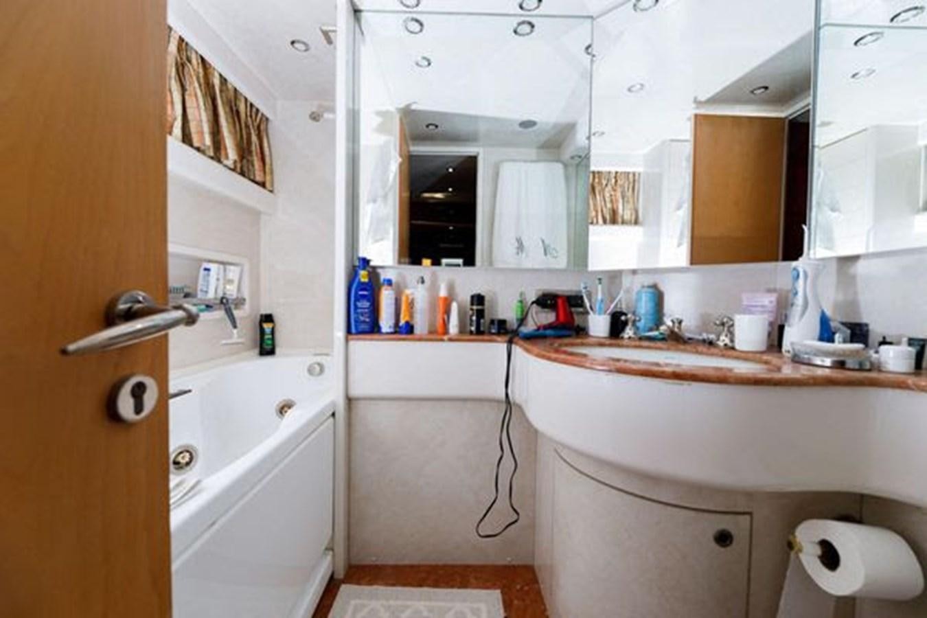 a bathroom with a sink and a mirror aboard 1997 MAIORA FIPA 70' FLYBRIDGE Yacht for Sale