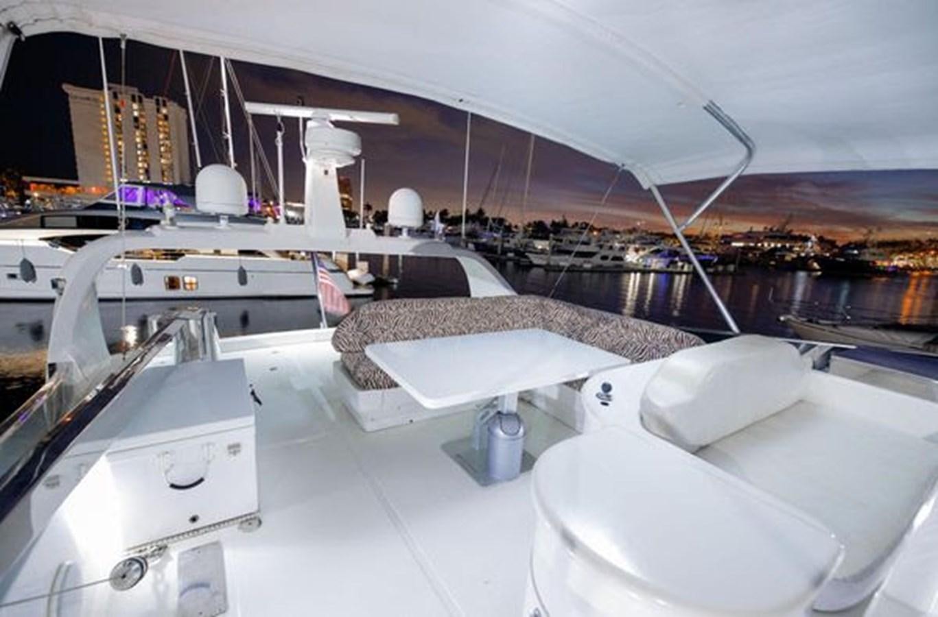 a room with several white beds aboard 1997 MAIORA FIPA 70' FLYBRIDGE Yacht for Sale