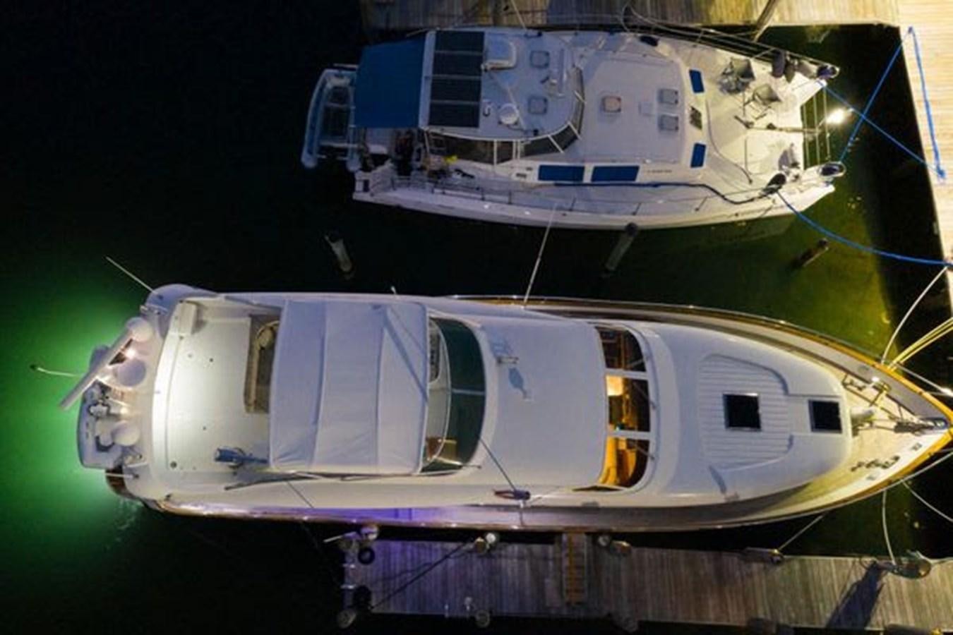 a couple of boats on a dock aboard 1997 MAIORA FIPA 70' FLYBRIDGE Yacht for Sale